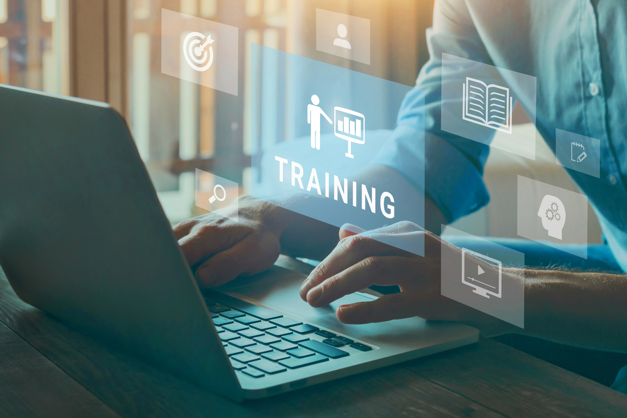 A person typing on a keyboard with icons floating in the air. One icon says training.
