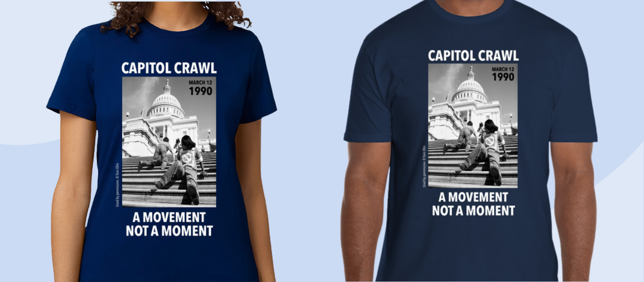Models wearing t-shirts with a photo of the Capitol Crawl and the words the a movement not a moment.