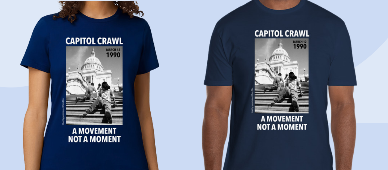 Models wearing t-shirts with a photo of the Capitol Crawl and the words the a movement not a moment.